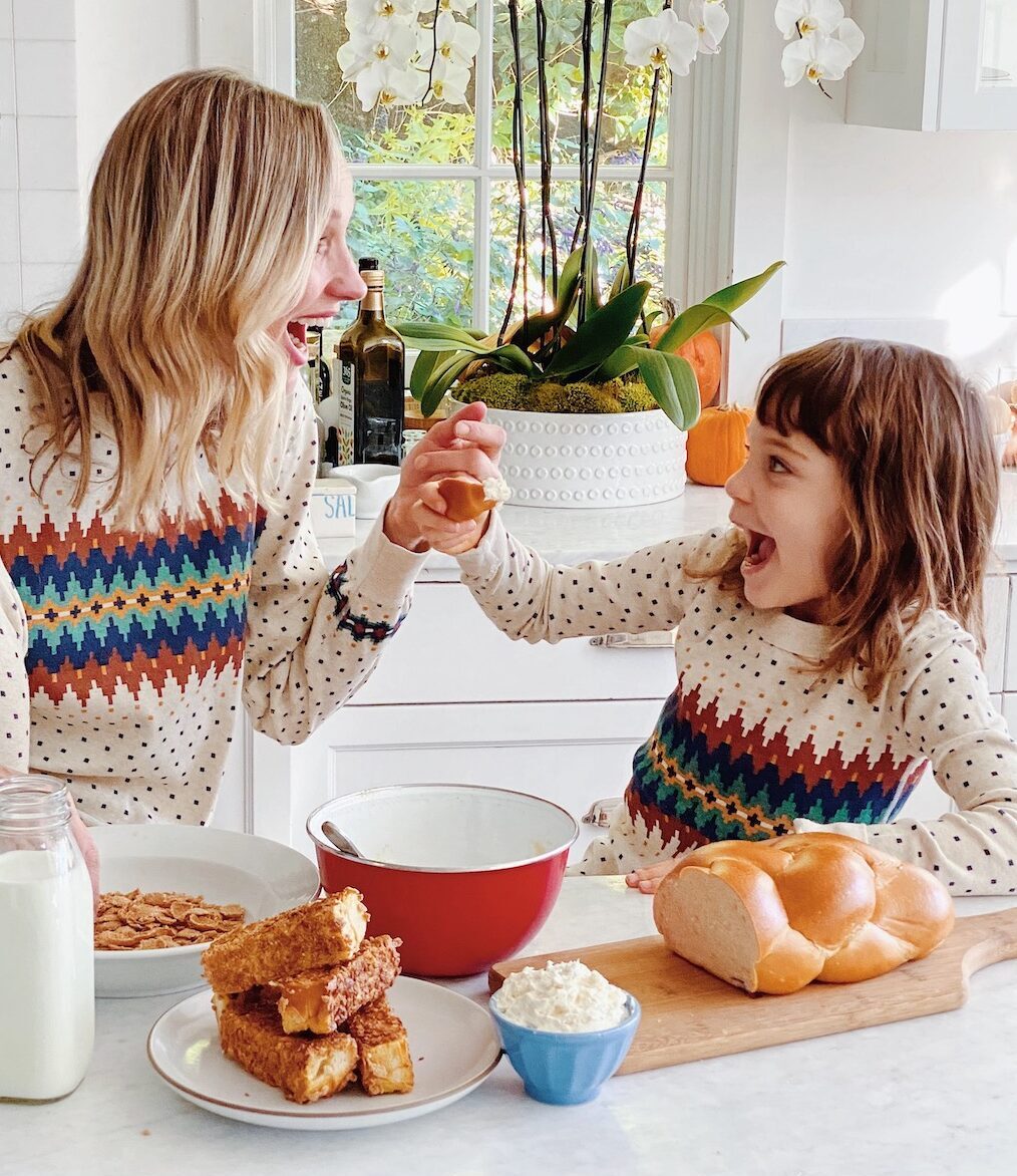Mother and daughter making food together in the kitchen.