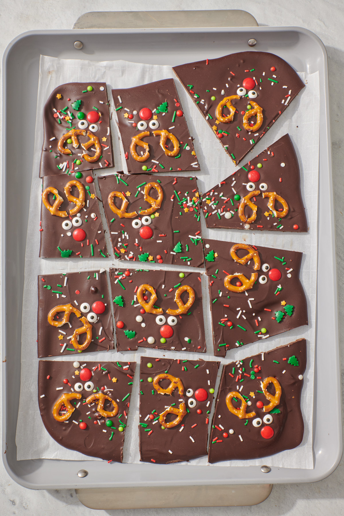 Chocolate reindeer bark pieces on baking sheet.