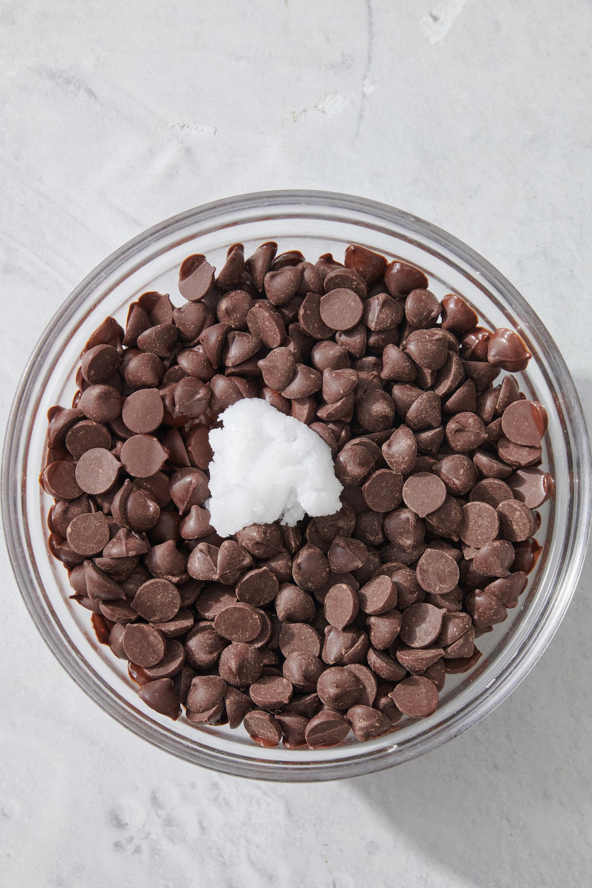 Chocolate chips and coconut oil in mixing bowl.