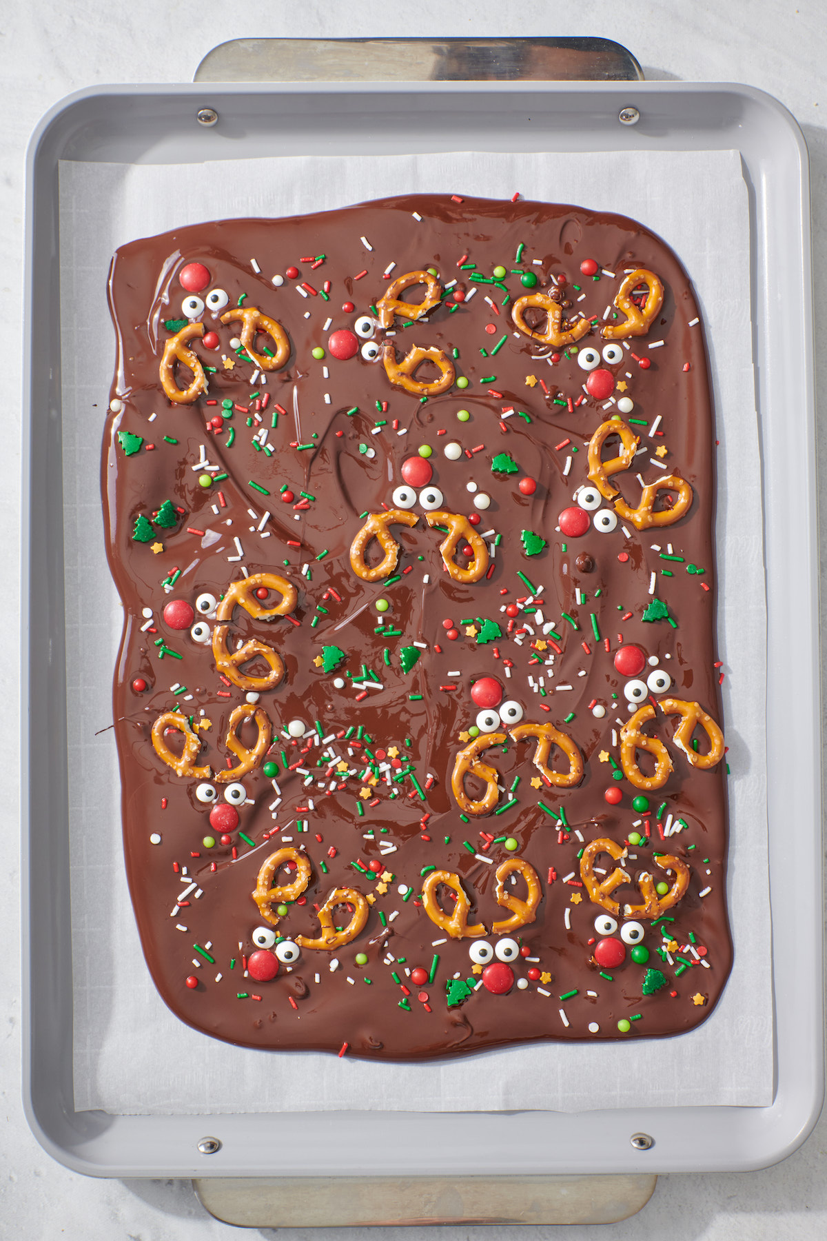 Melted chocolate with sprinkles and reindeer faces.