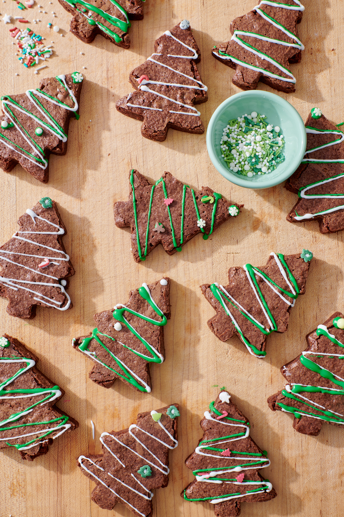 Christmas Tree Shaped Brownies with frosting and sprinkles.