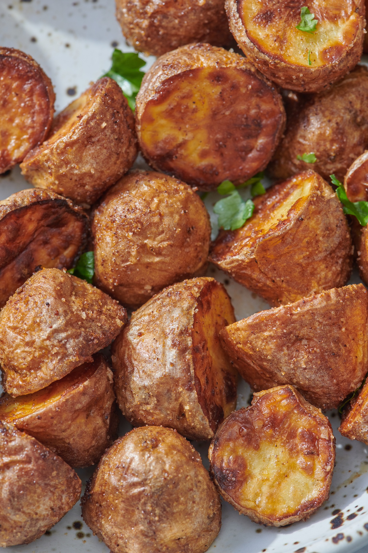 Crispy air fried baby potatoes on plate.