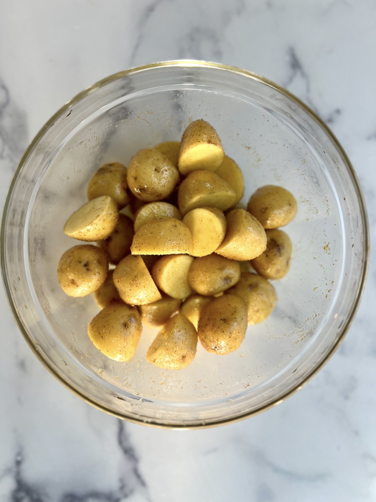 Baby potatoes prepped in mixing bowl.