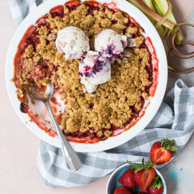 Strawberry rhubarb crumble topped with ice cream.