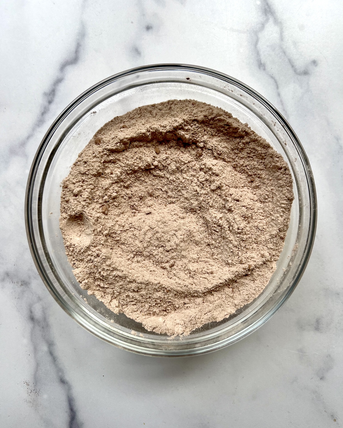 Chocolate zucchini bread dry ingredients in a bowl.