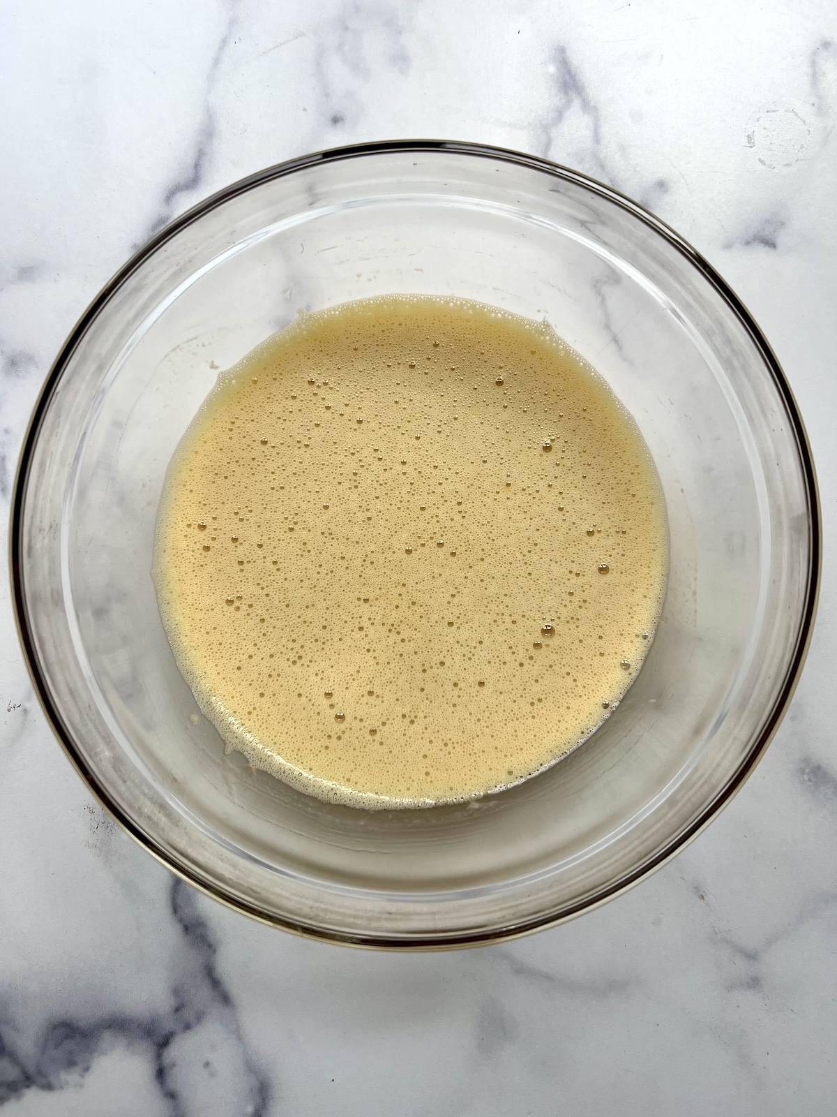 Chocolate zucchini bread wet ingredients in a bowl.