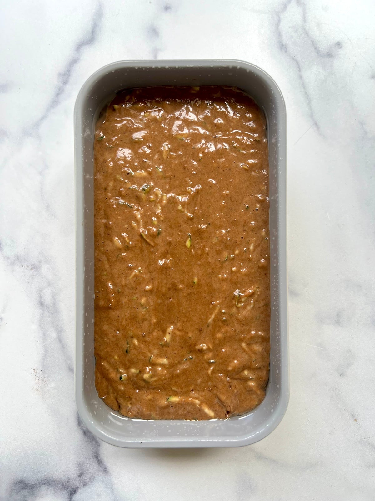 Chocolate zucchini bread batter in a 9x5 inch loaf pan.