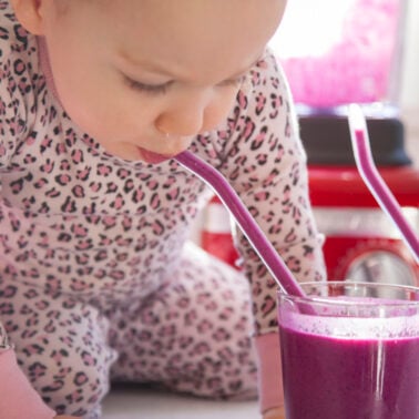 Toddler drinking smoothie.