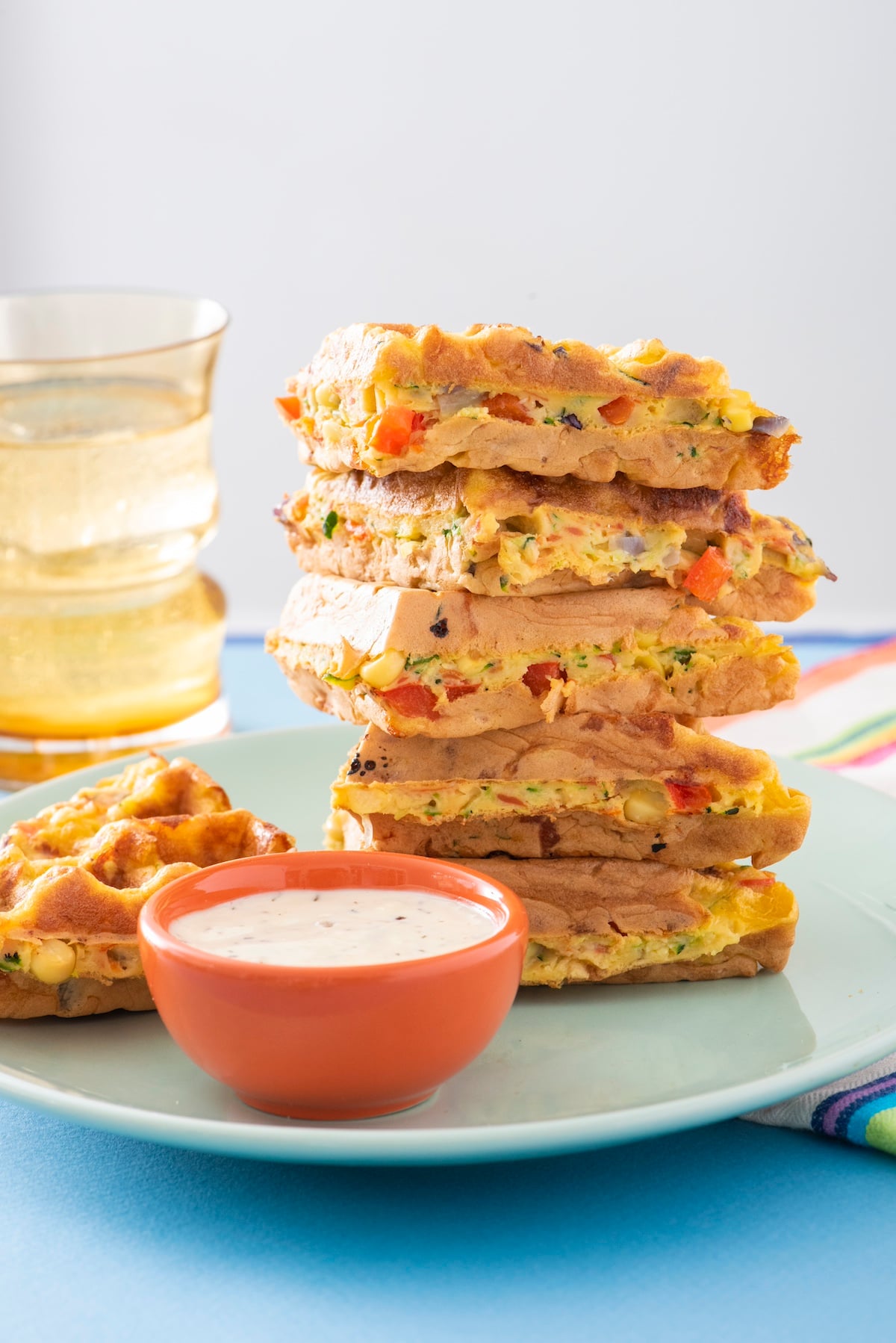 Rainbow waffle pieces stacked on plate.