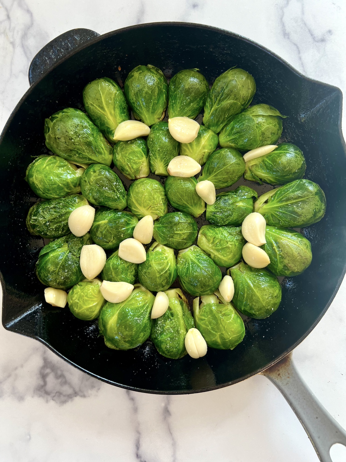 Brussels sprouts and garlic in cast iron skillet.