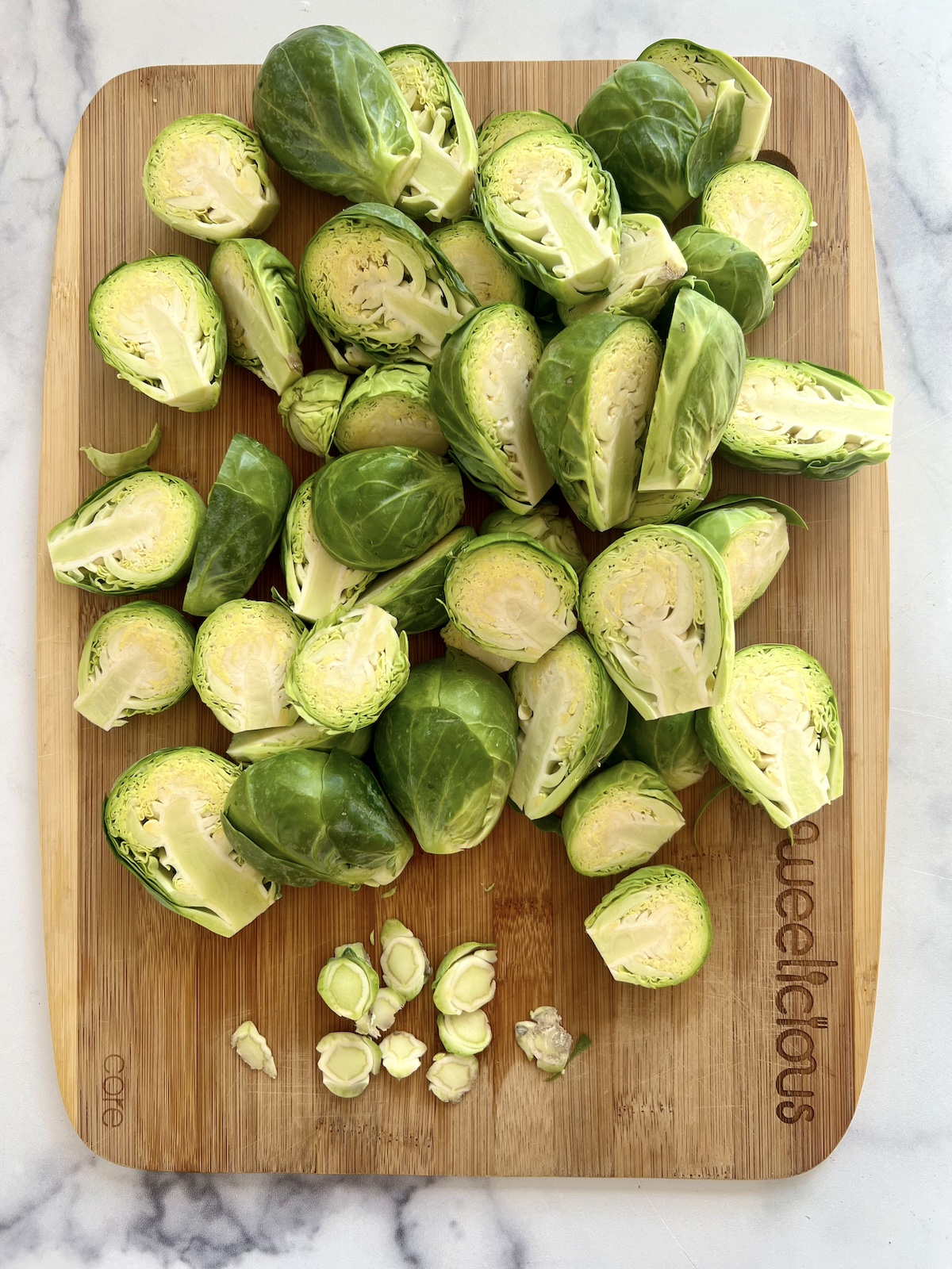 Trimmed brussels sprouts on a cutting board.