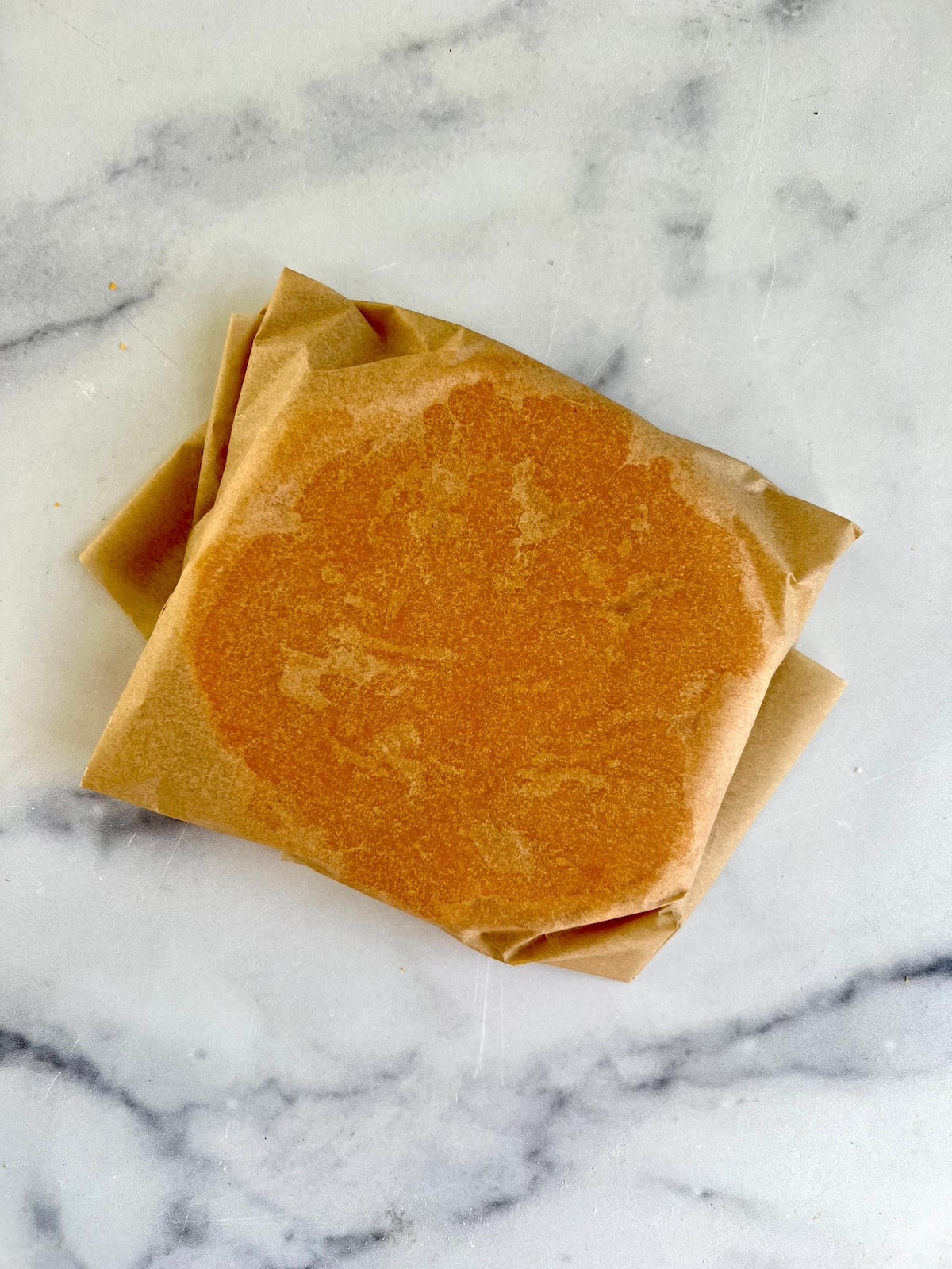 Cheese wafer wrapped in parchment paper.