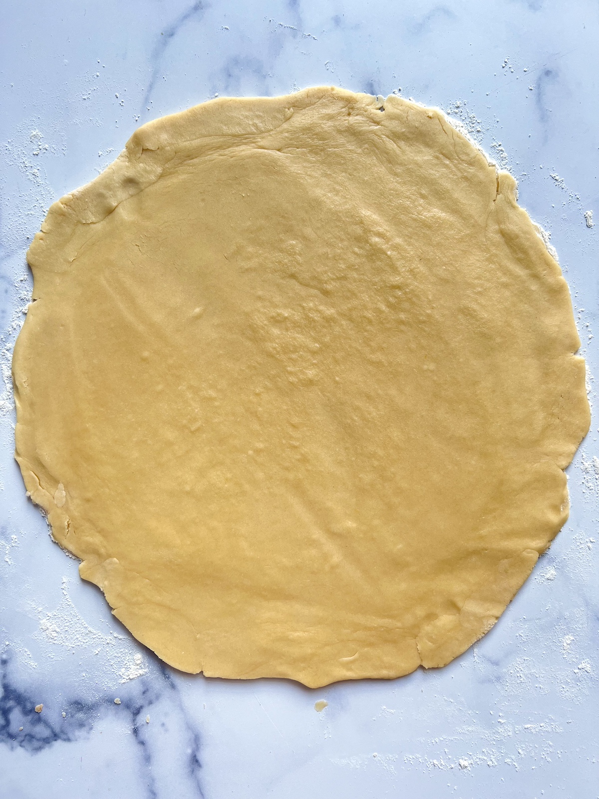 Sugar cookie dough rolled out onto counter.