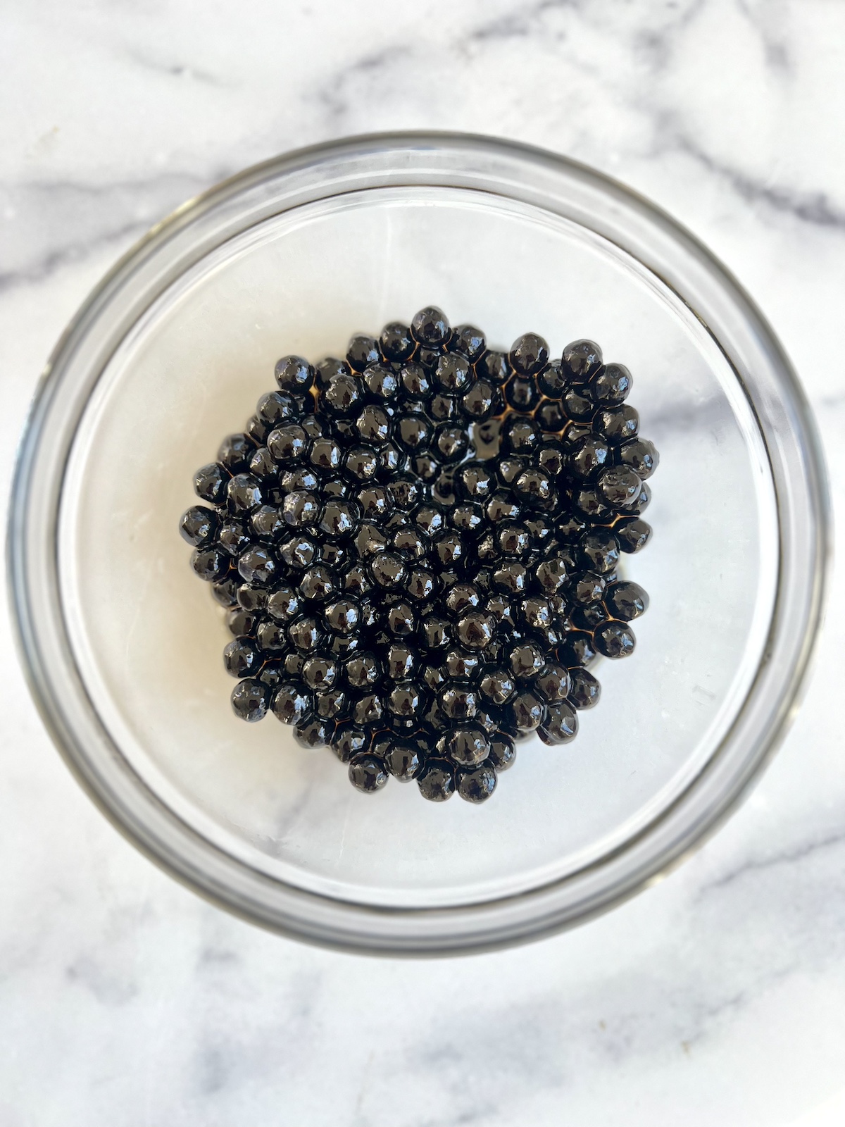 Boba in small bowl coated with honey.