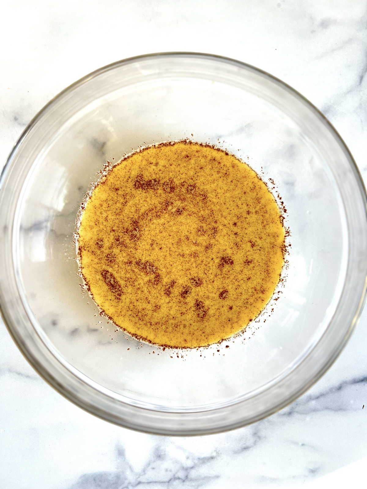 Custard mixture in a mixing bowl.
