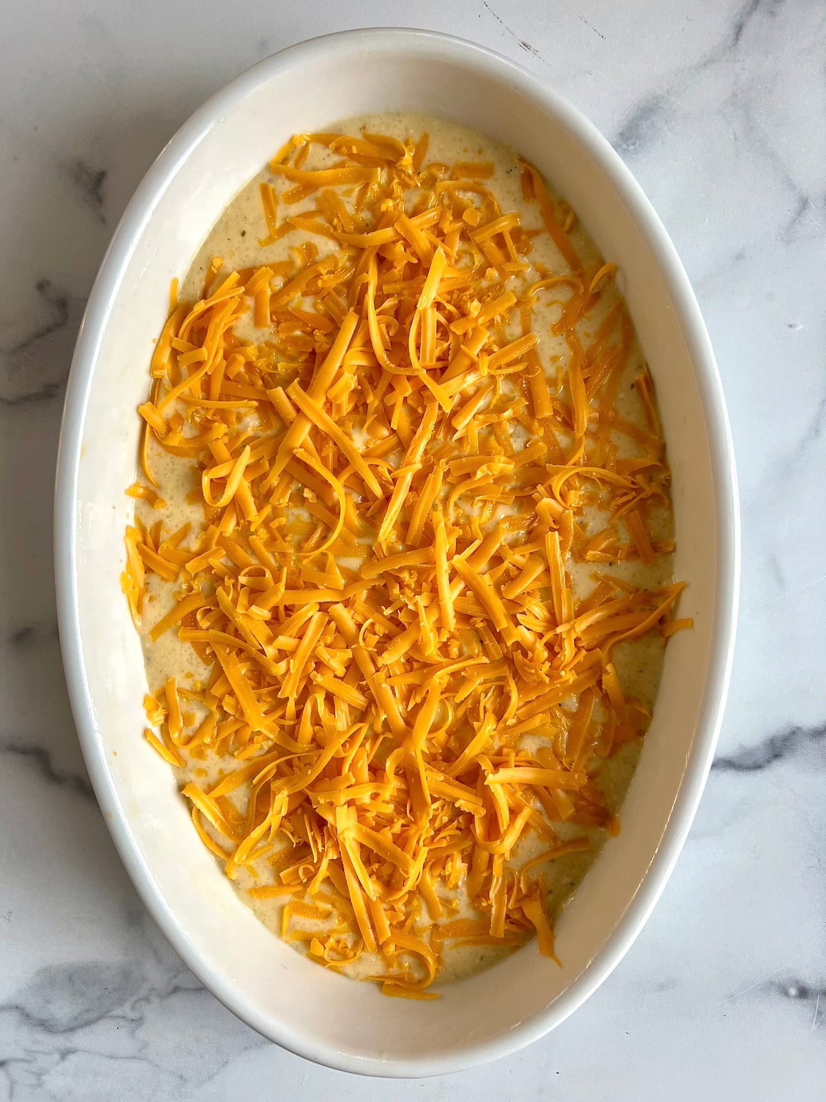 Cheese grits in baking dish ready to be put into the oven.