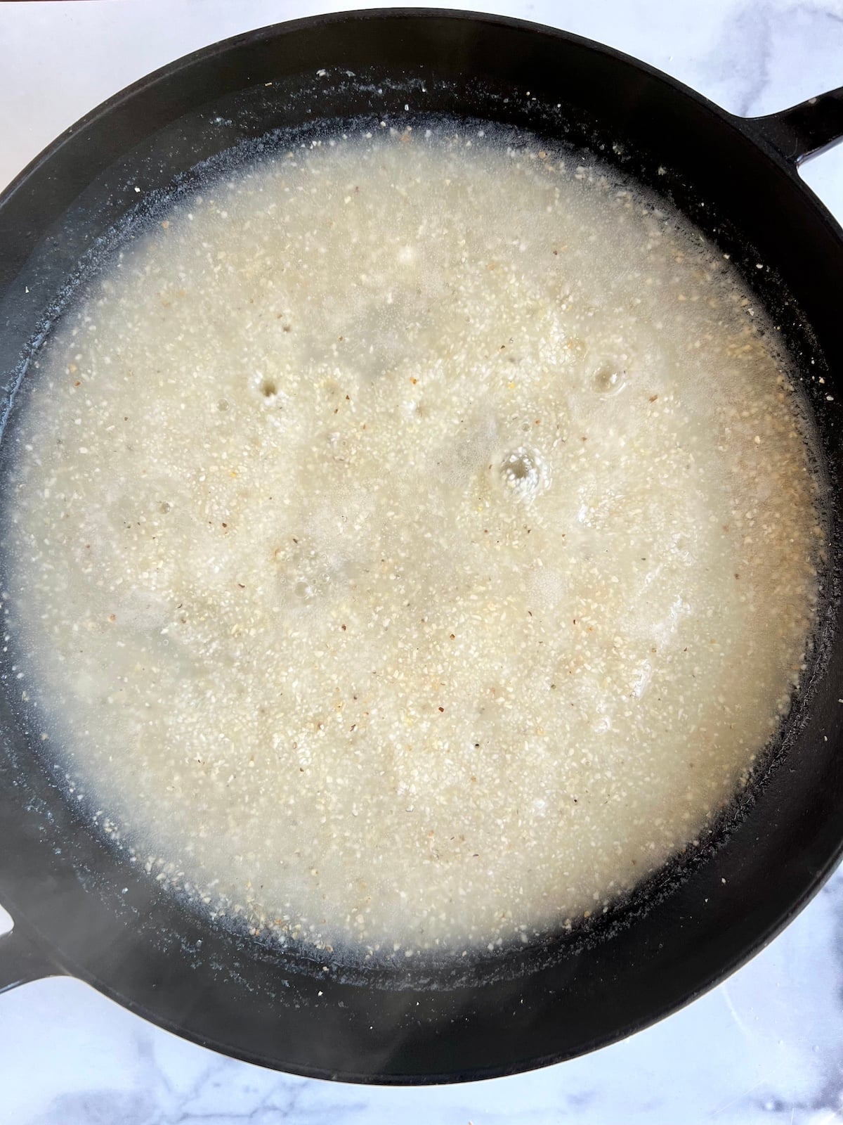 Grits boiling in a pot of water.