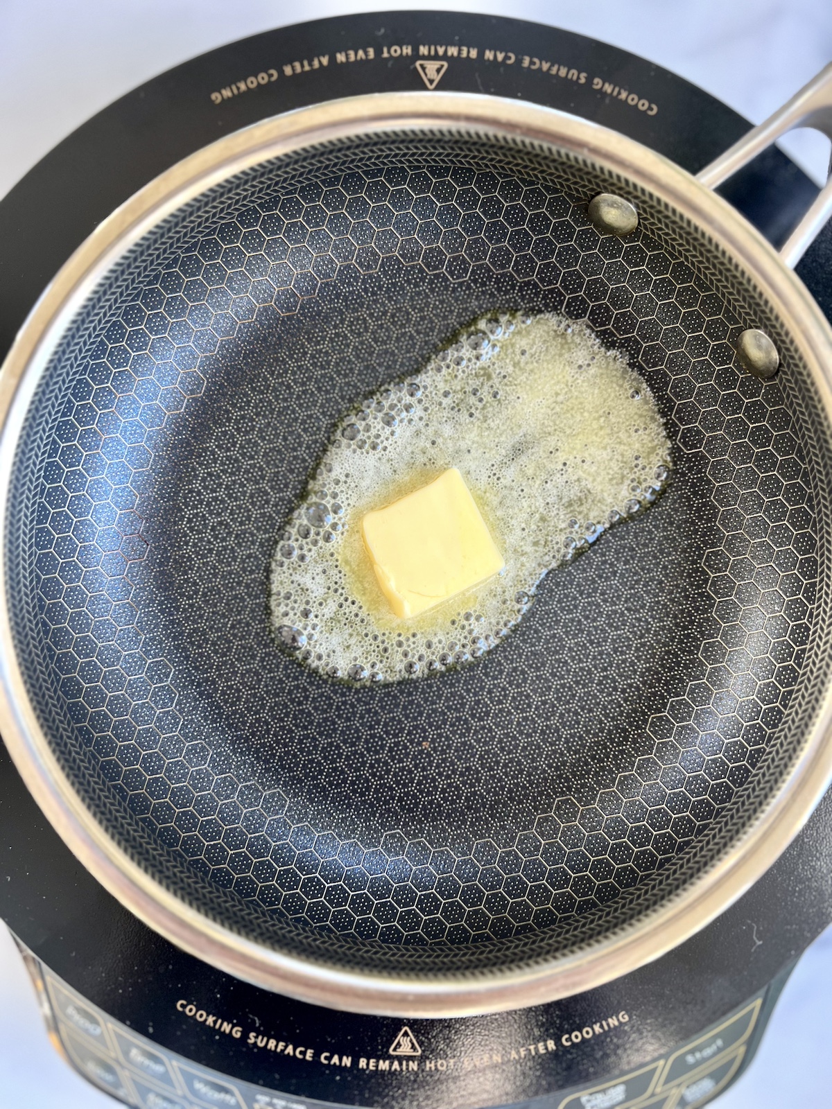 Butter melting in a skillet.
