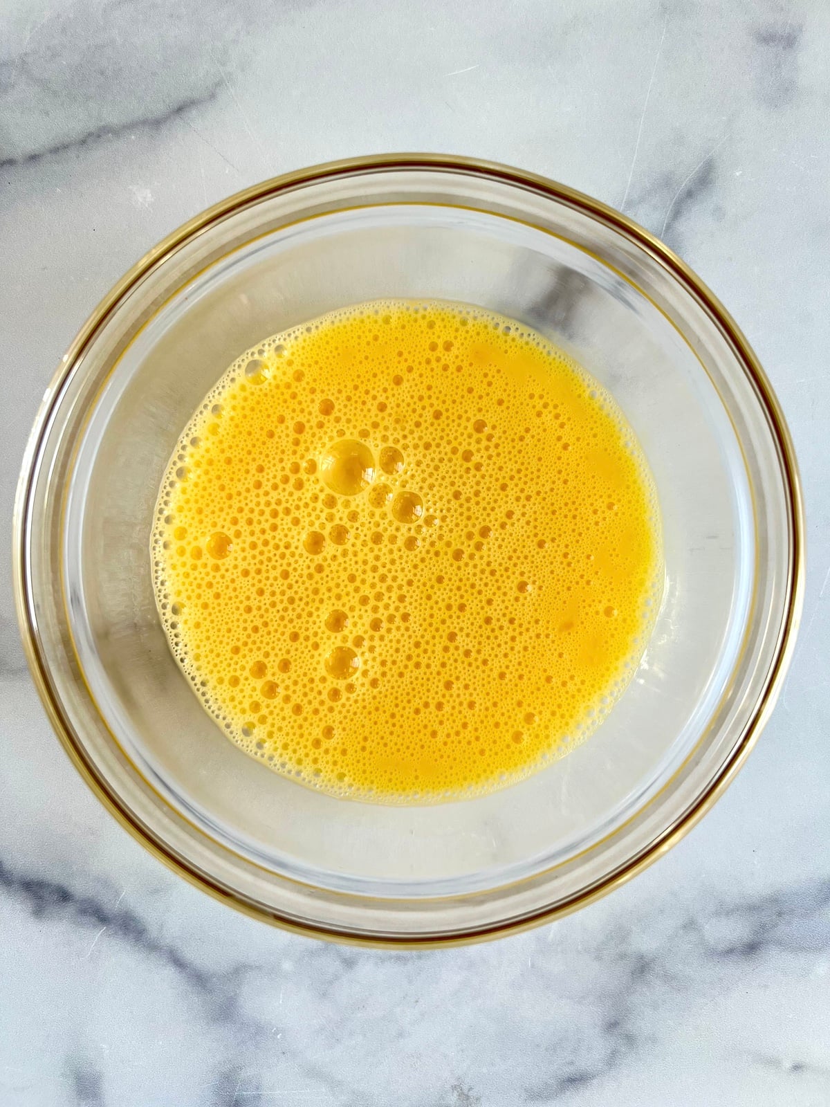 Whisked eggs in a bowl.