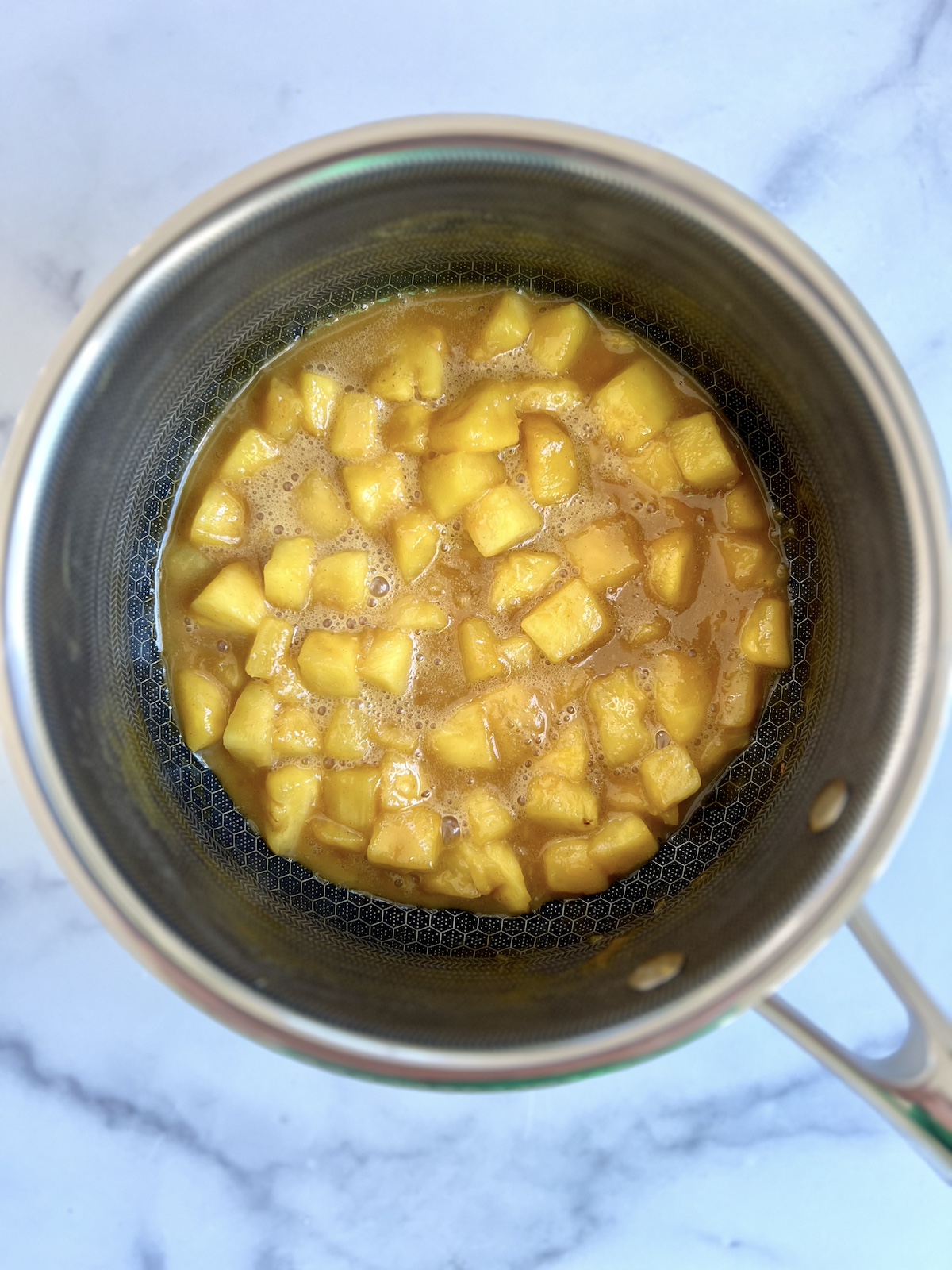 Pineapple and brown sugar in a saucepan.