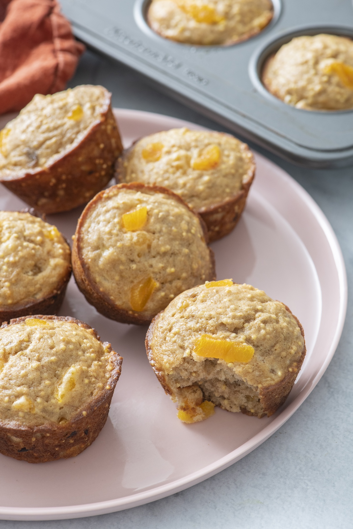 Apricot millet muffins on a plate.