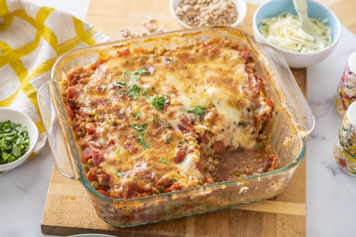 Baked farro with lentils, tomato and mozzarella in baking dish.