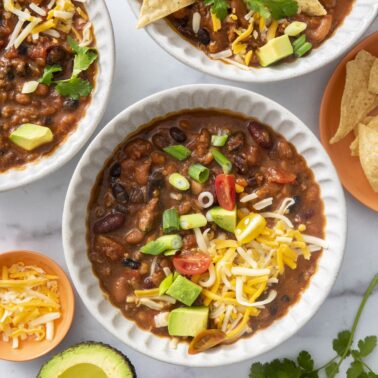 Four bean chili topped with cheese.