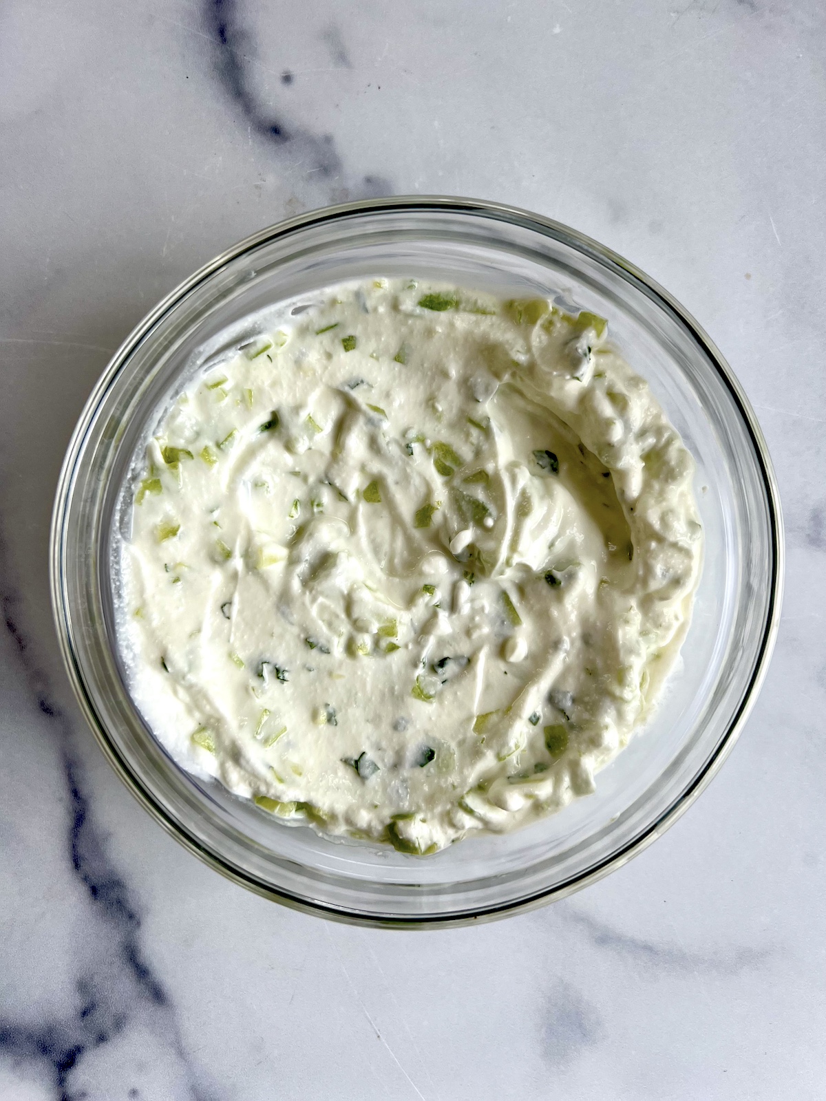Cucumber mint yogurt sauce in a mixing bowl.