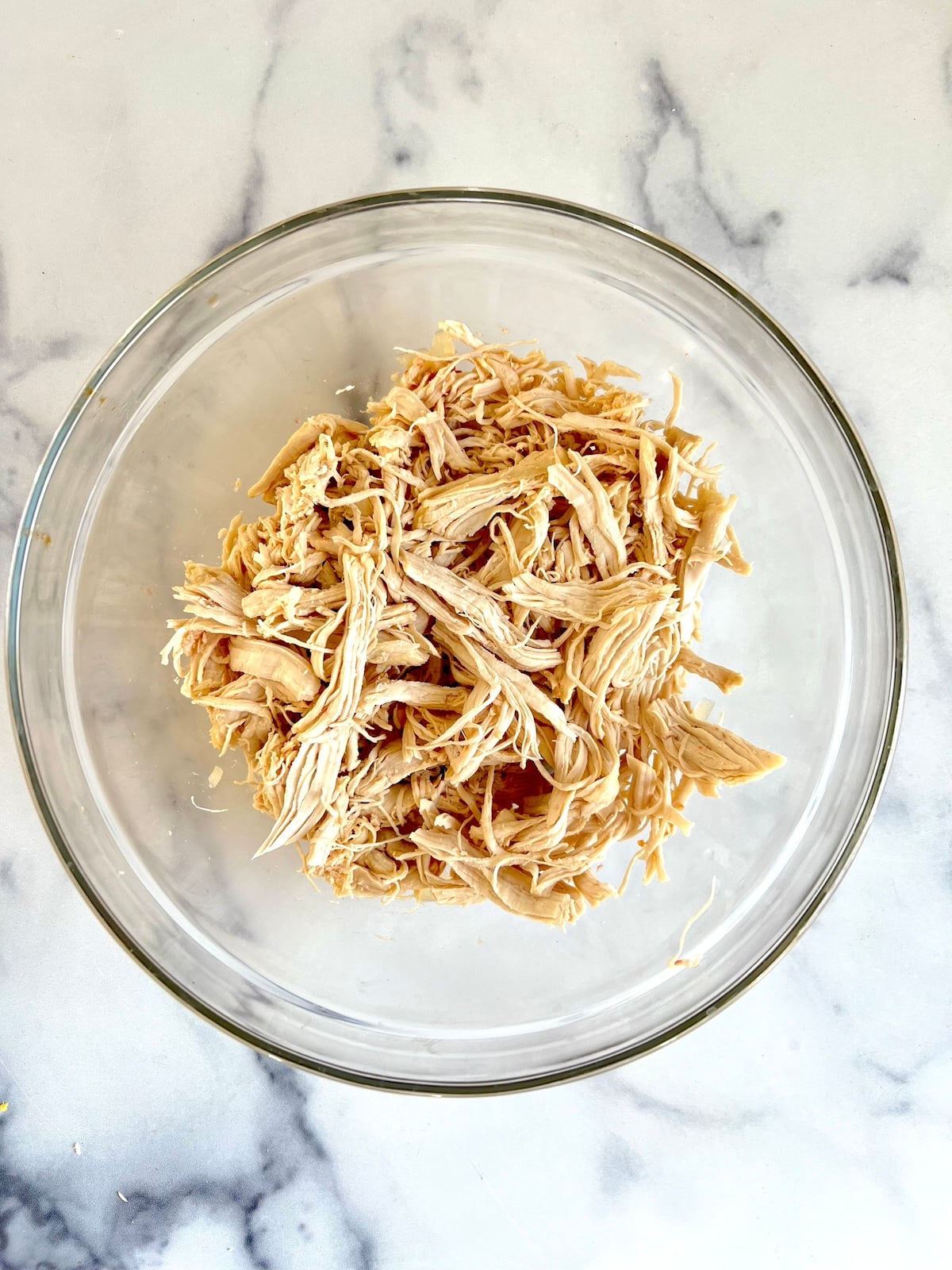 Shredded chicken in a bowl.