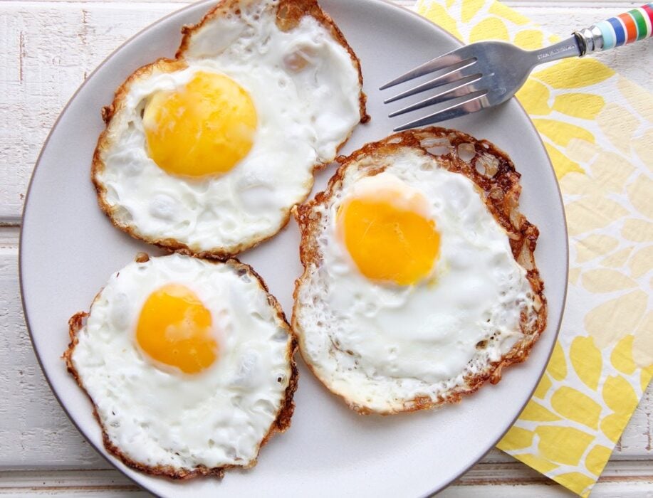 Three Crispy Fried Eggs on a plate.