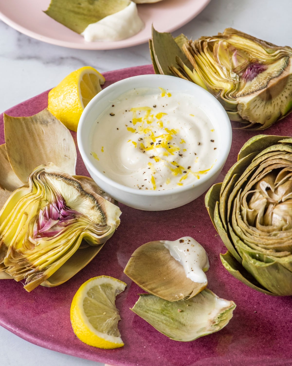 Steamed artichokes with a lemon yogurt dipping sauce.