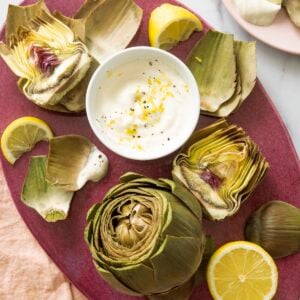 Steamed artichokes served with lemon yogurt sauce.