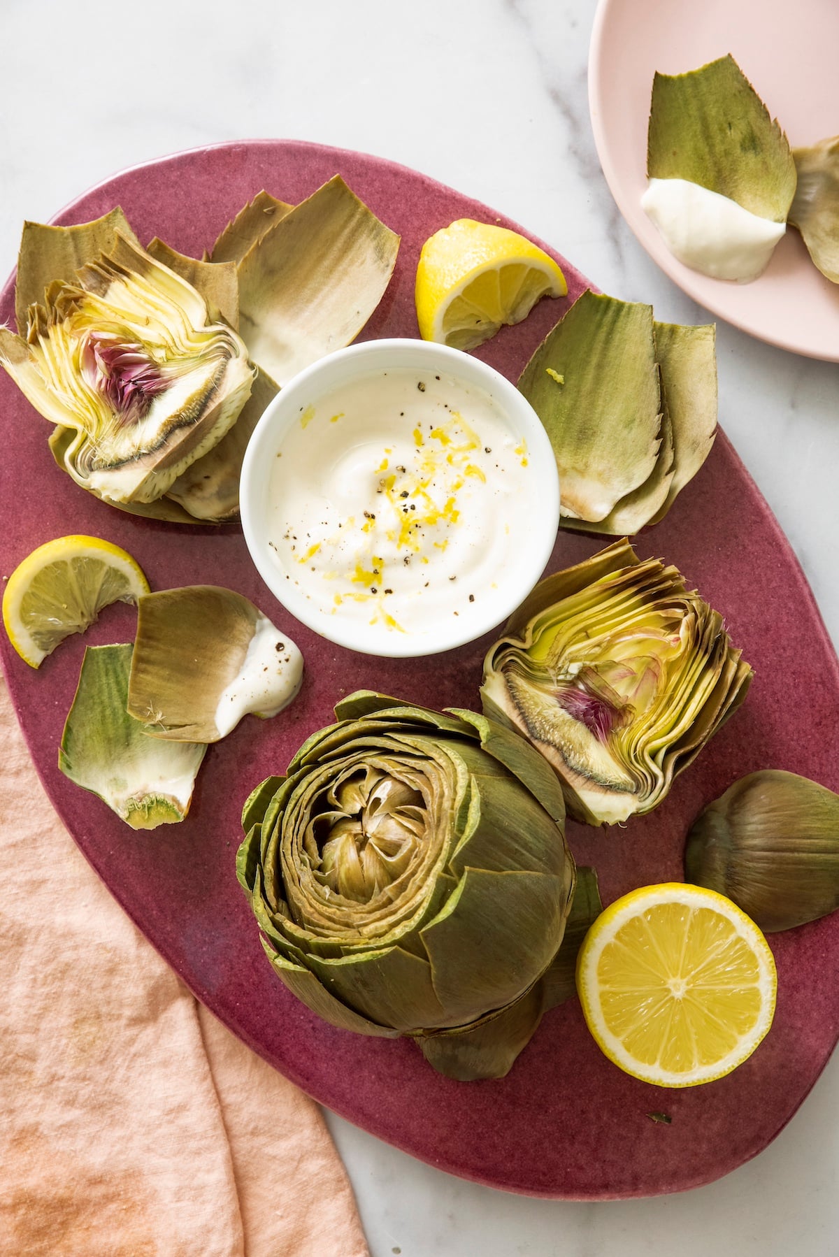 Steamed artichokes served with lemon yogurt sauce.