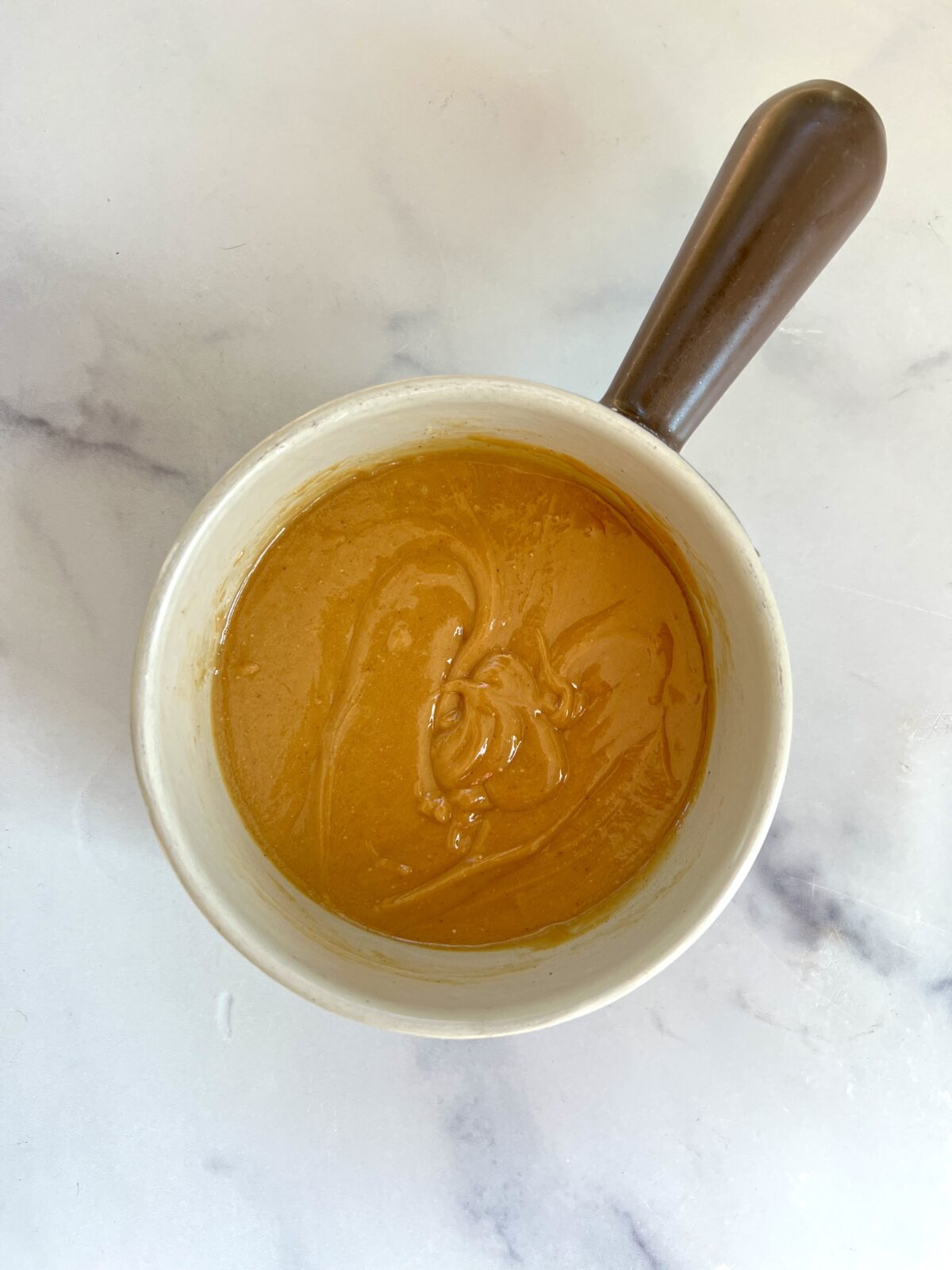 Peanut butter and honey combined in sauce pan.