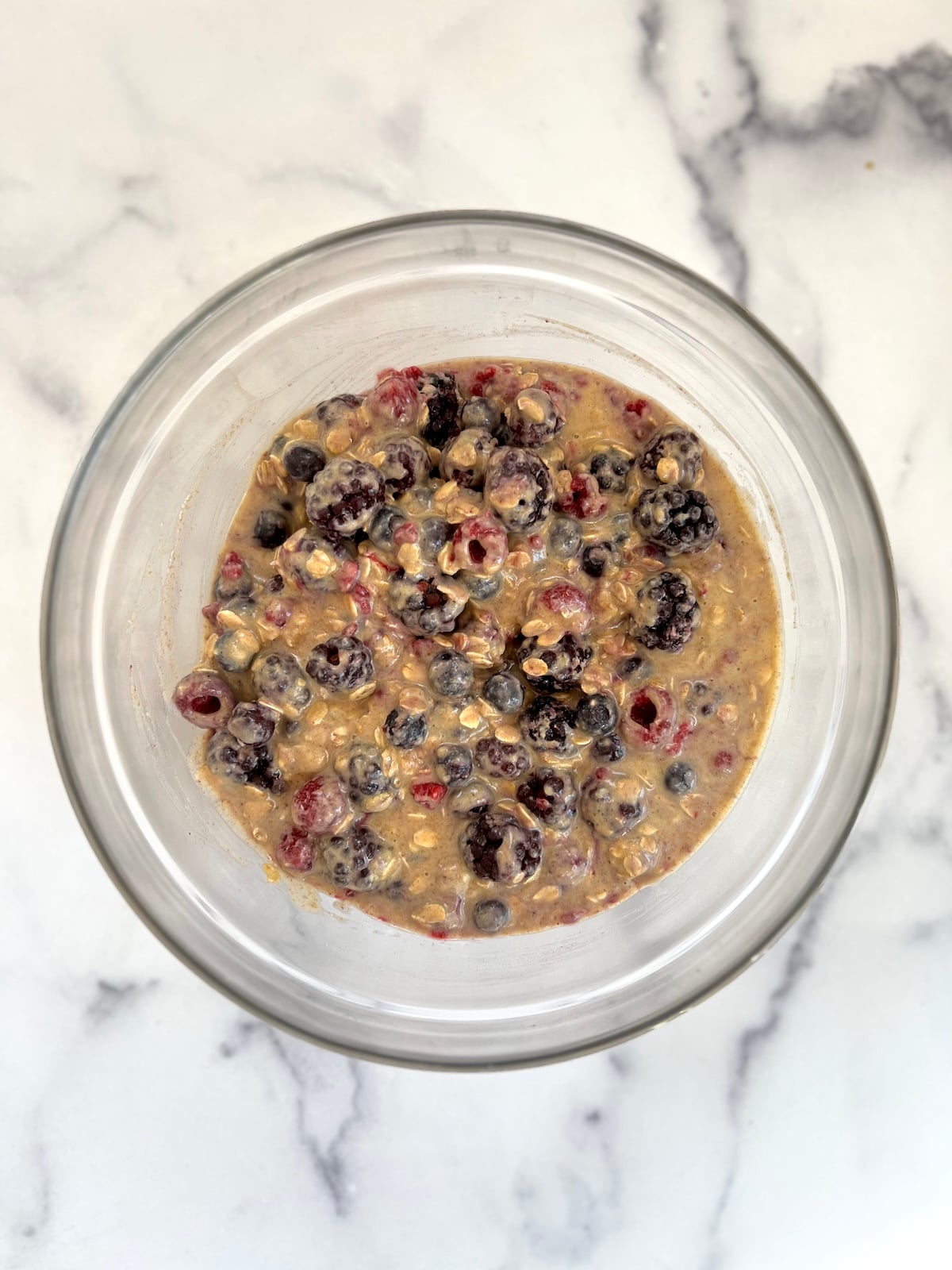 Very berry muffins batter in a mixing bowl.