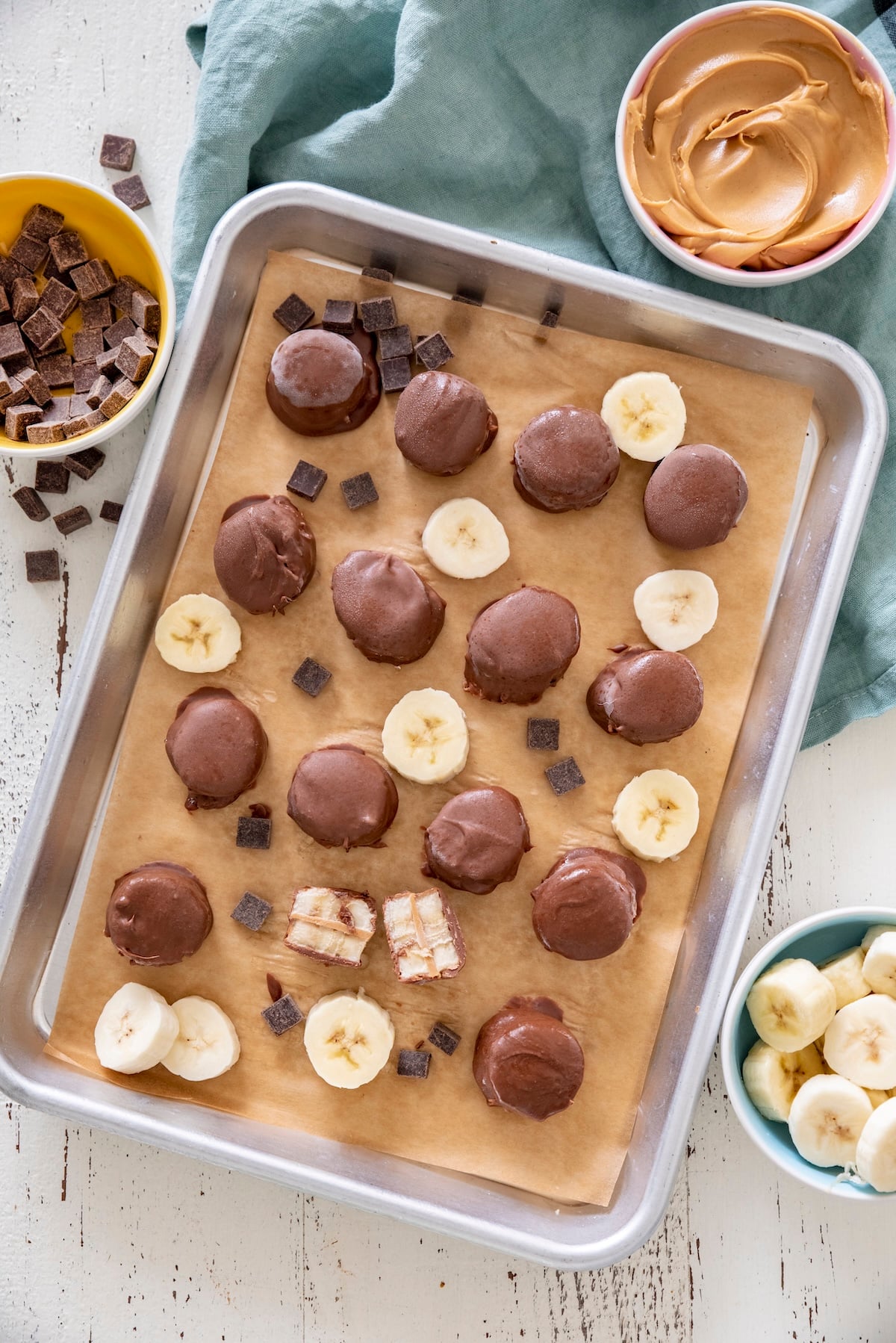 Frozen chocolate peanut butter bites on a sheet tray.