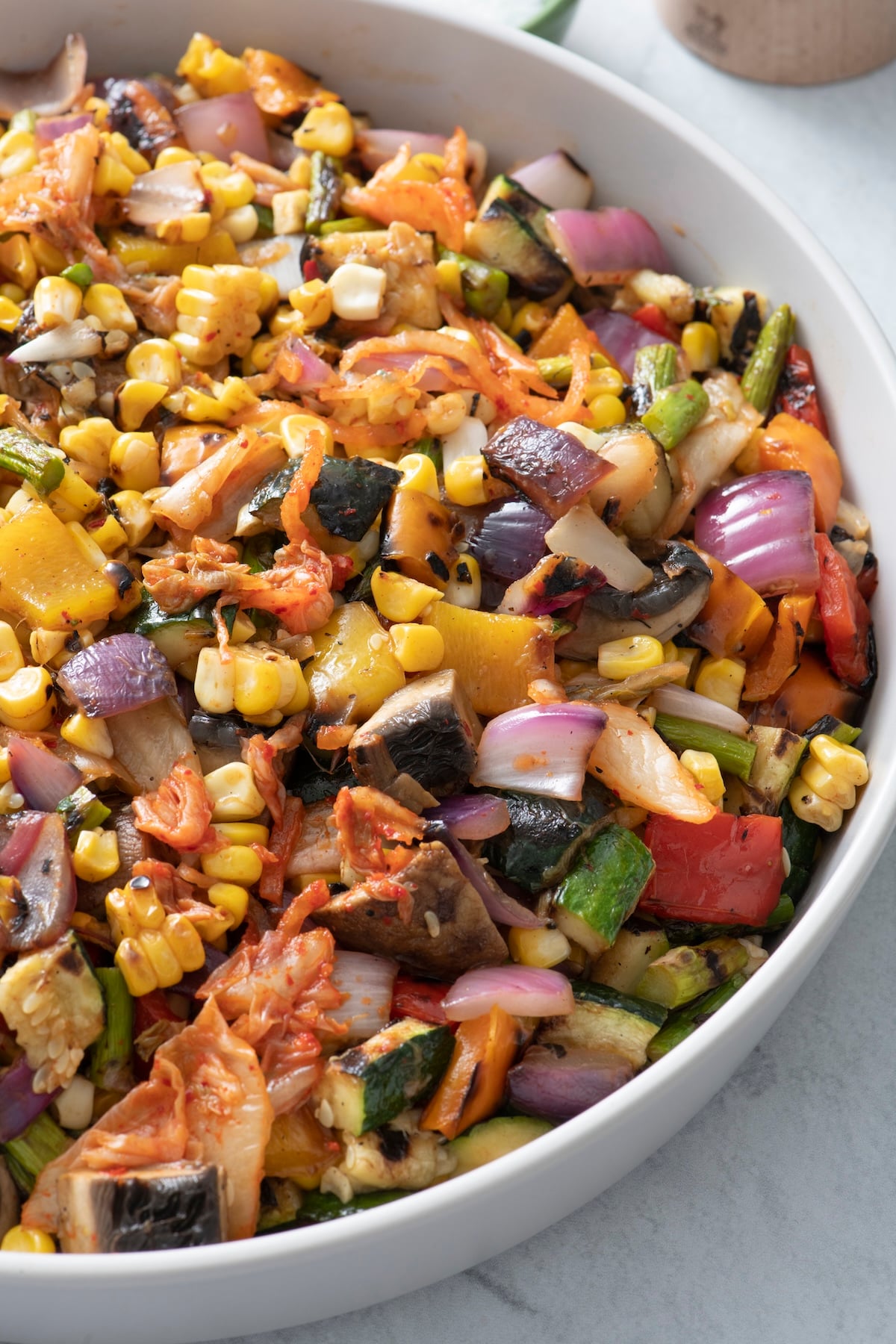 Grilled vegetable kimchi salad in a large bowl.