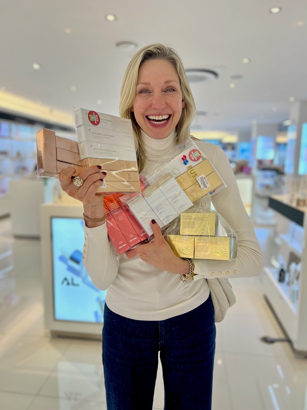 Catherine posing with Korean skincare items.