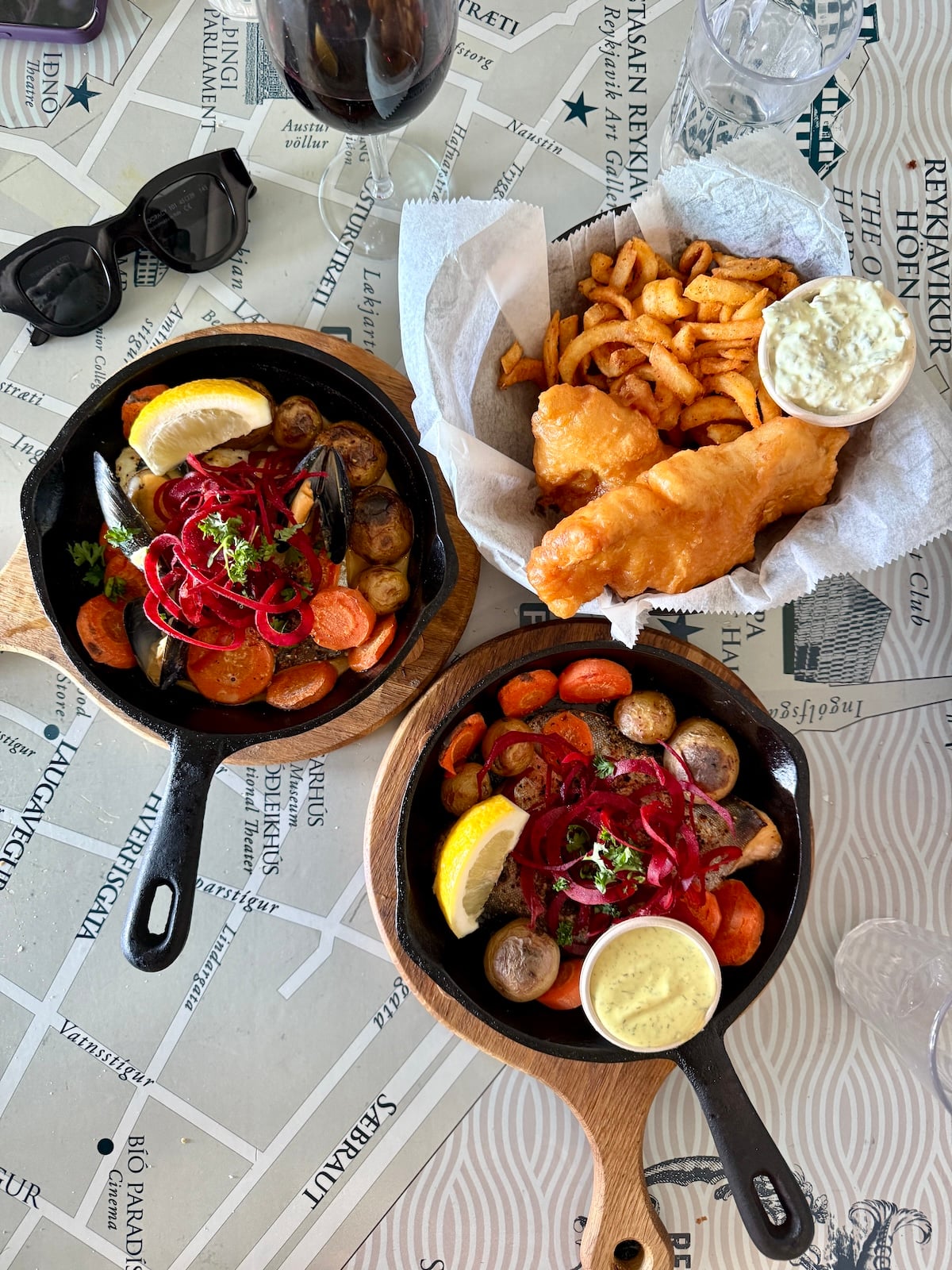 Fish and chips along with another seafood dish.