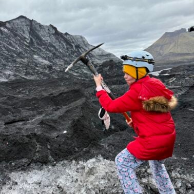 Girl with a pickax on a glacier in Iceland.
