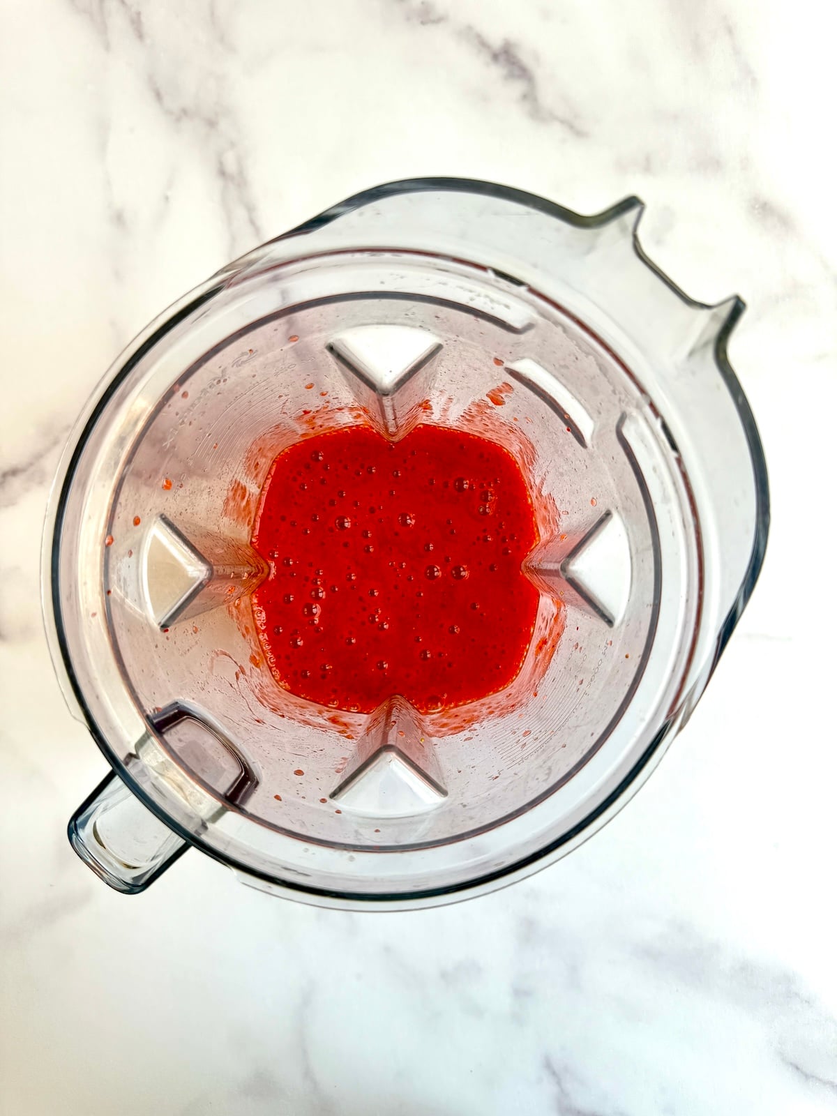 Pureed strawberries in a blender.