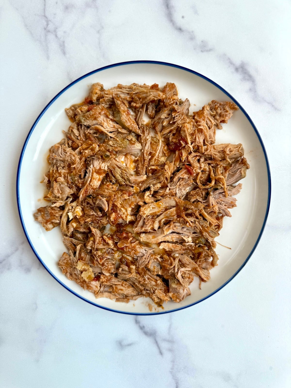 Shredded pork on a large plate.