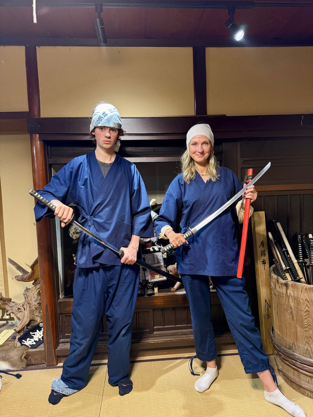 Woman and son holding ninja swords.