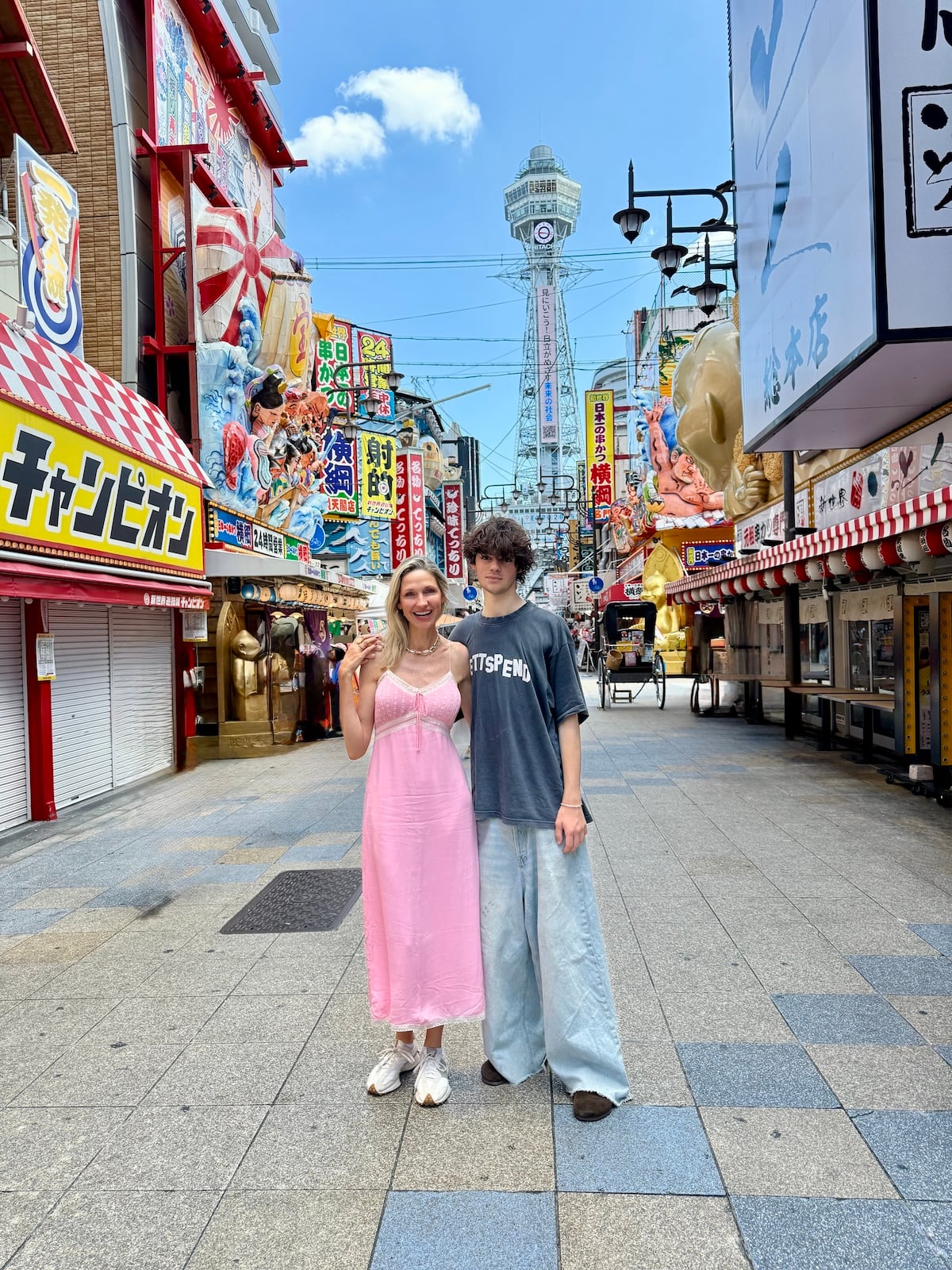 Woman and son standing in Shinsekai district in Japan.