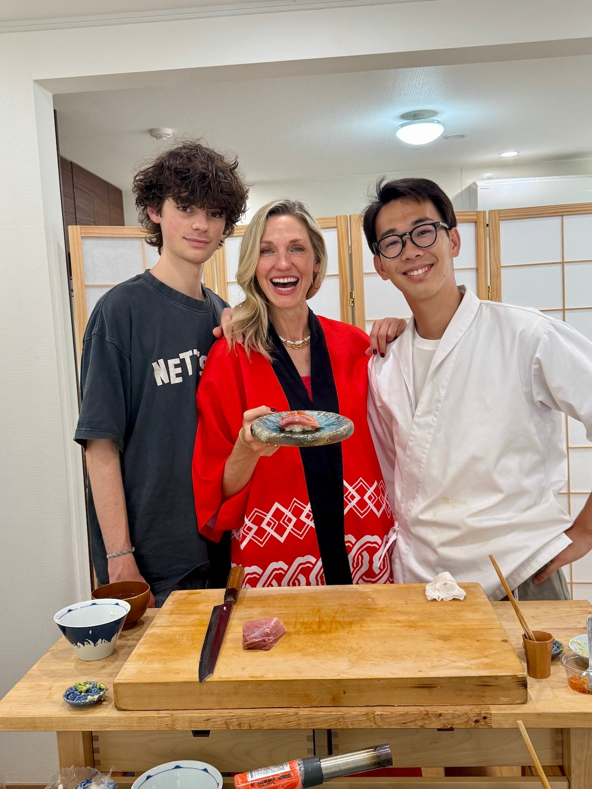 Mother and son with a sushi chef.