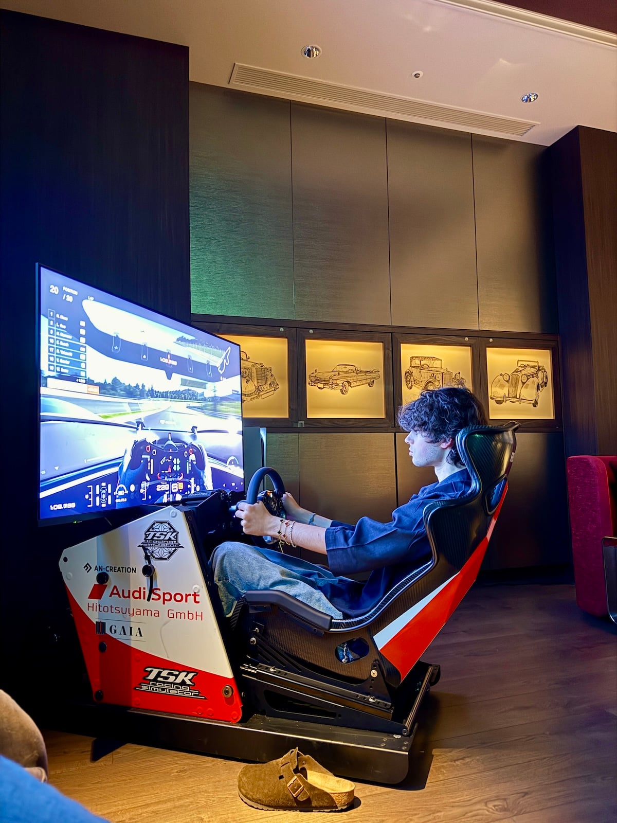 Man driving a racecar simulator.