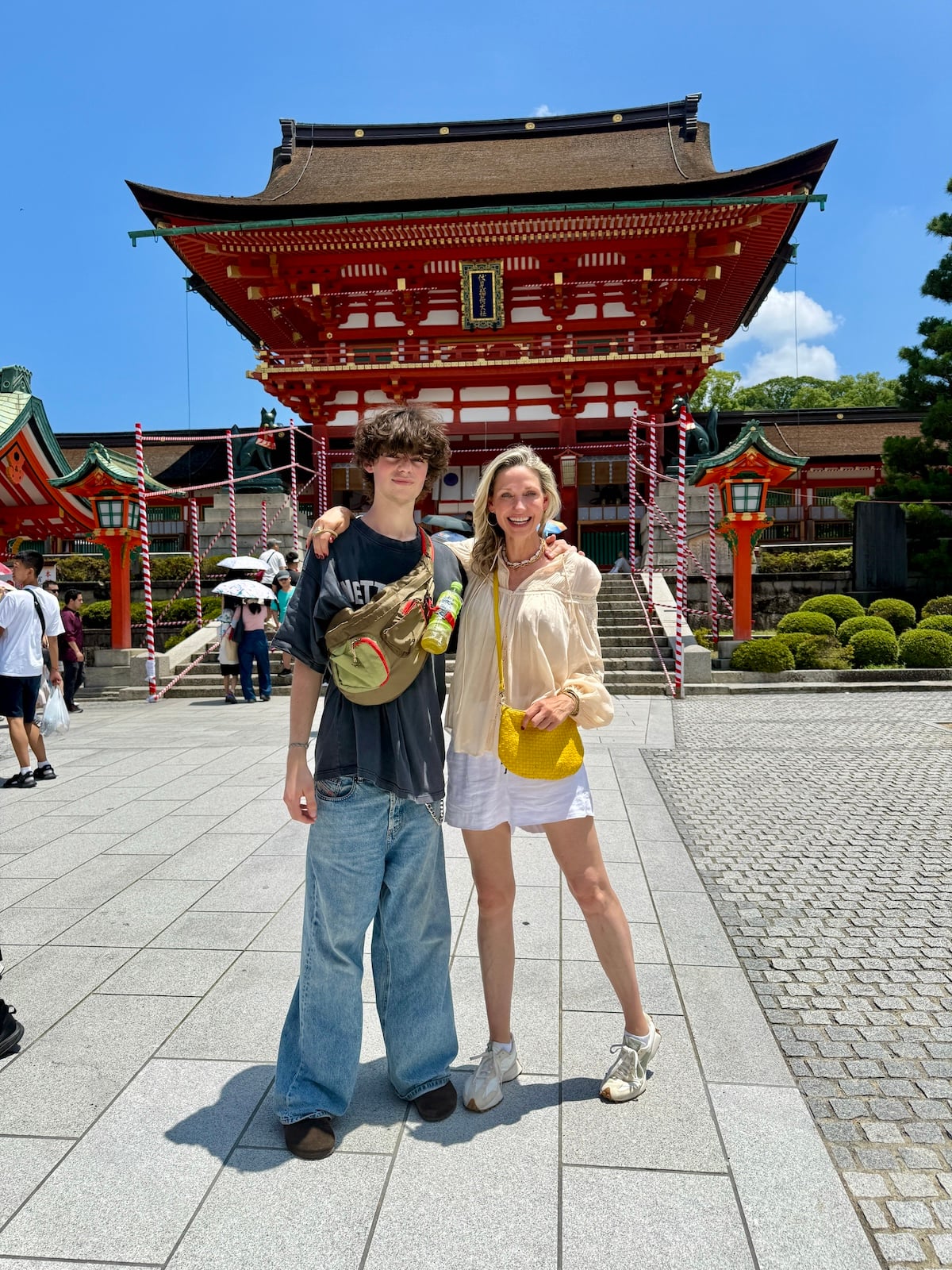 Woman and boy in front of Fushimi Inari shrine.