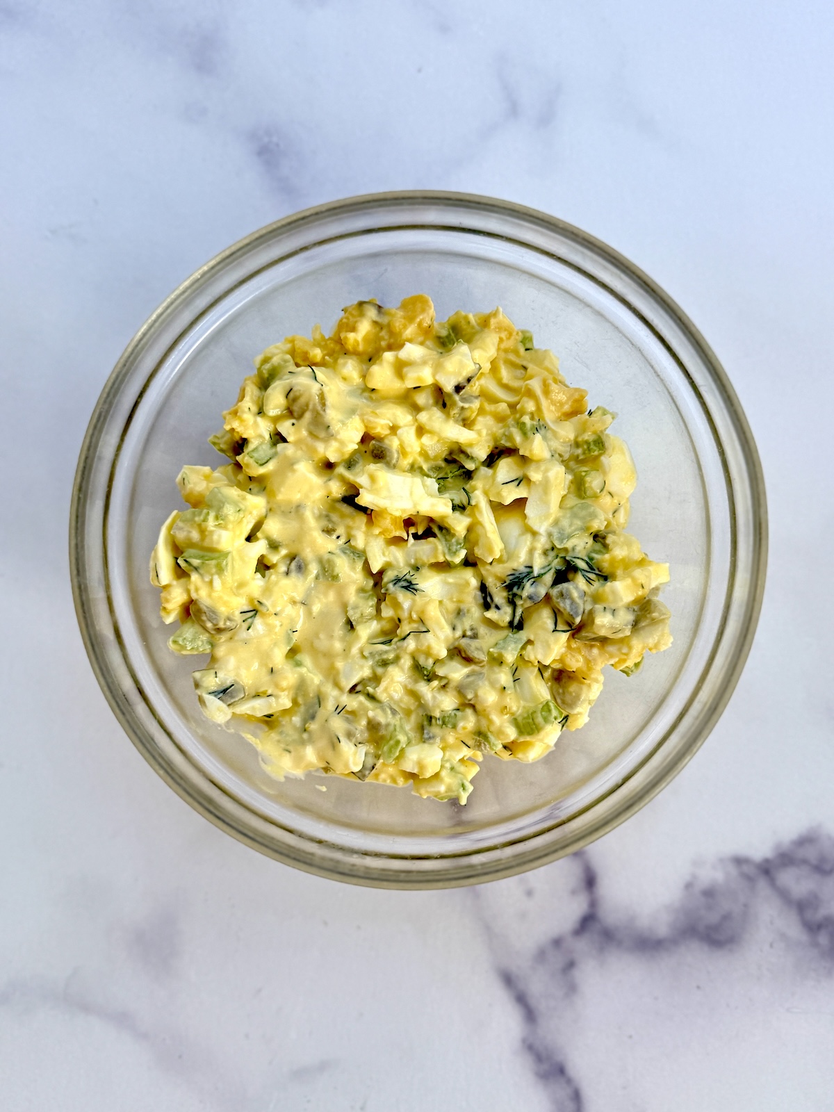 Egg salad in a glass bowl.