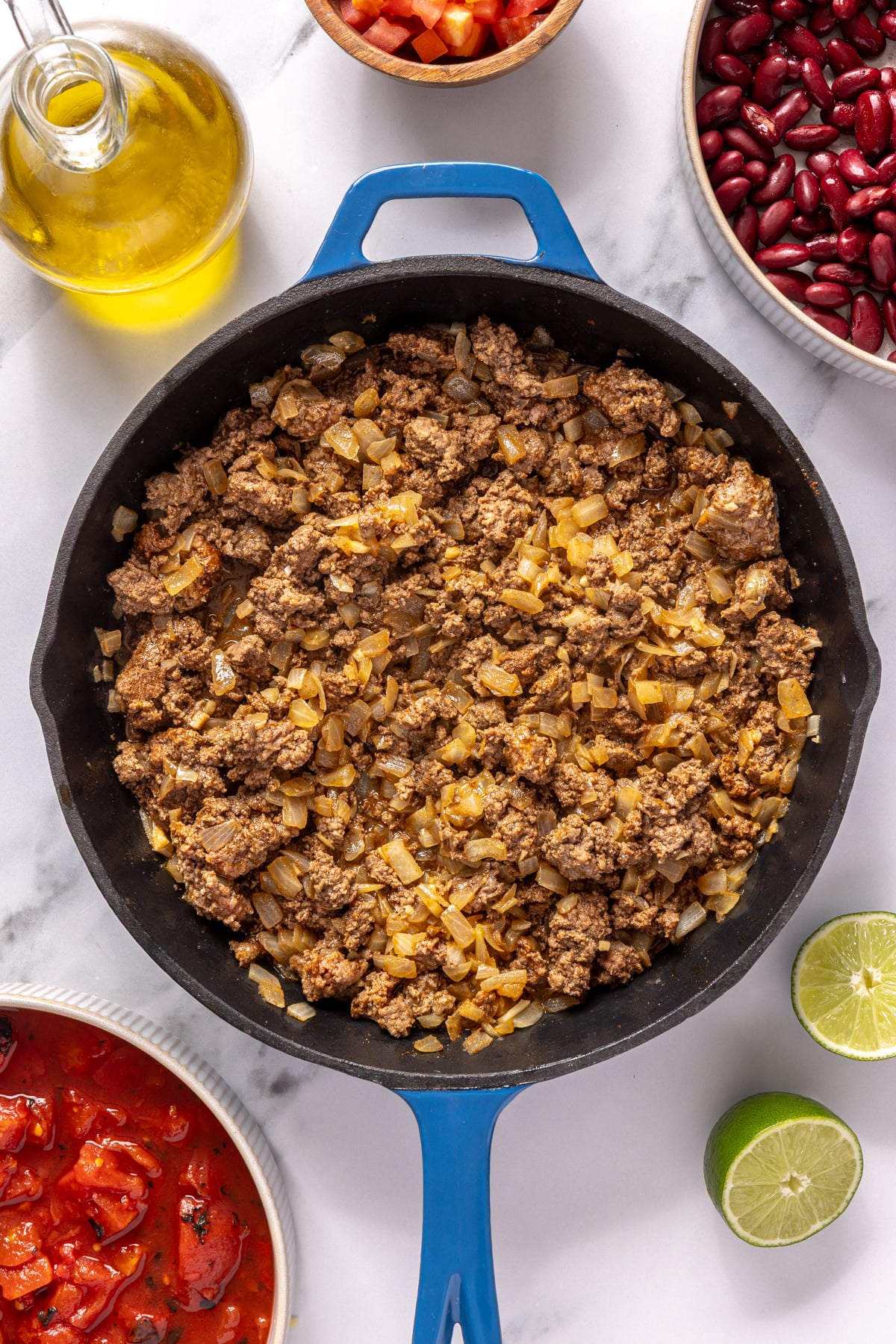 Ground beef and spices added to cast iron with onions and garlic.