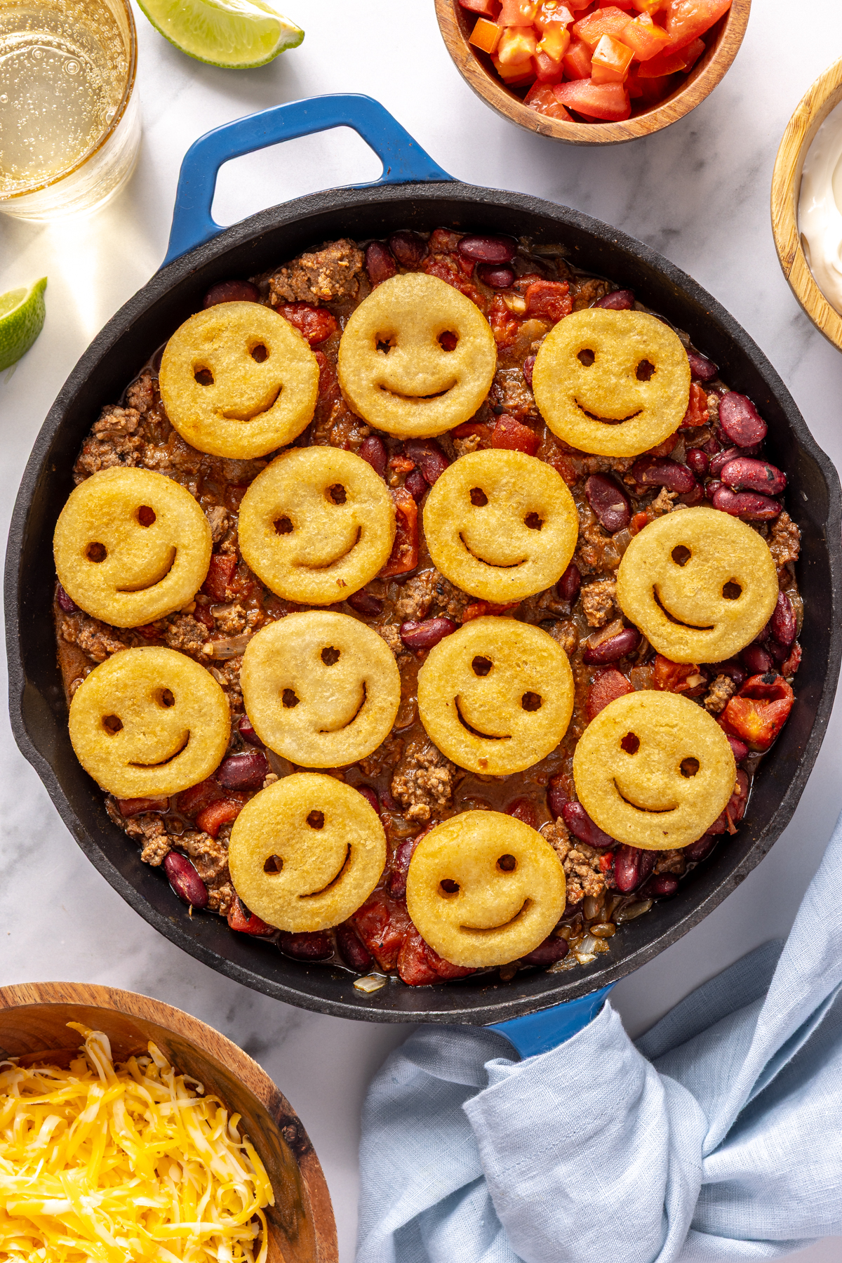Skillet beef chili topped with smile shaped fries.